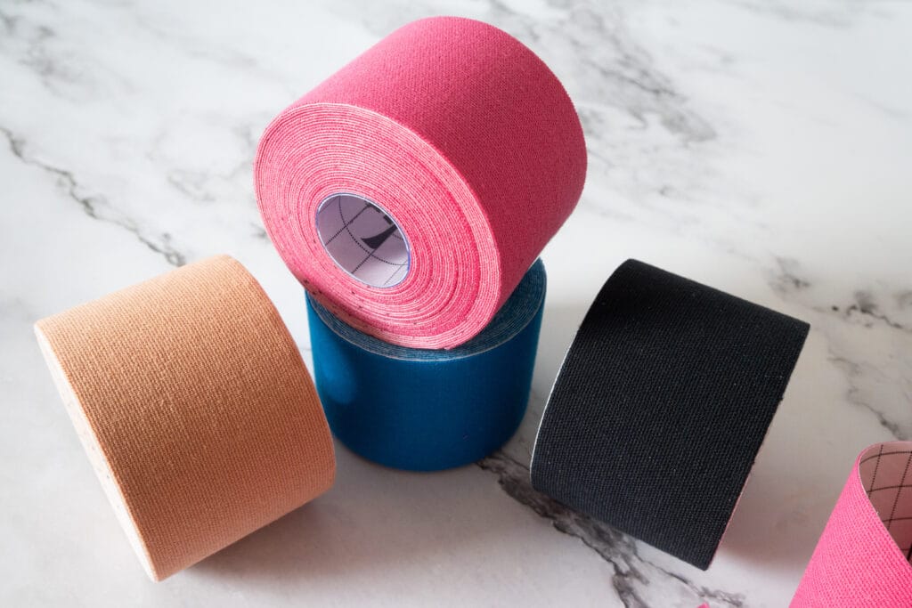 Elastic medical tapes in various colors, applied in physical therapy.
