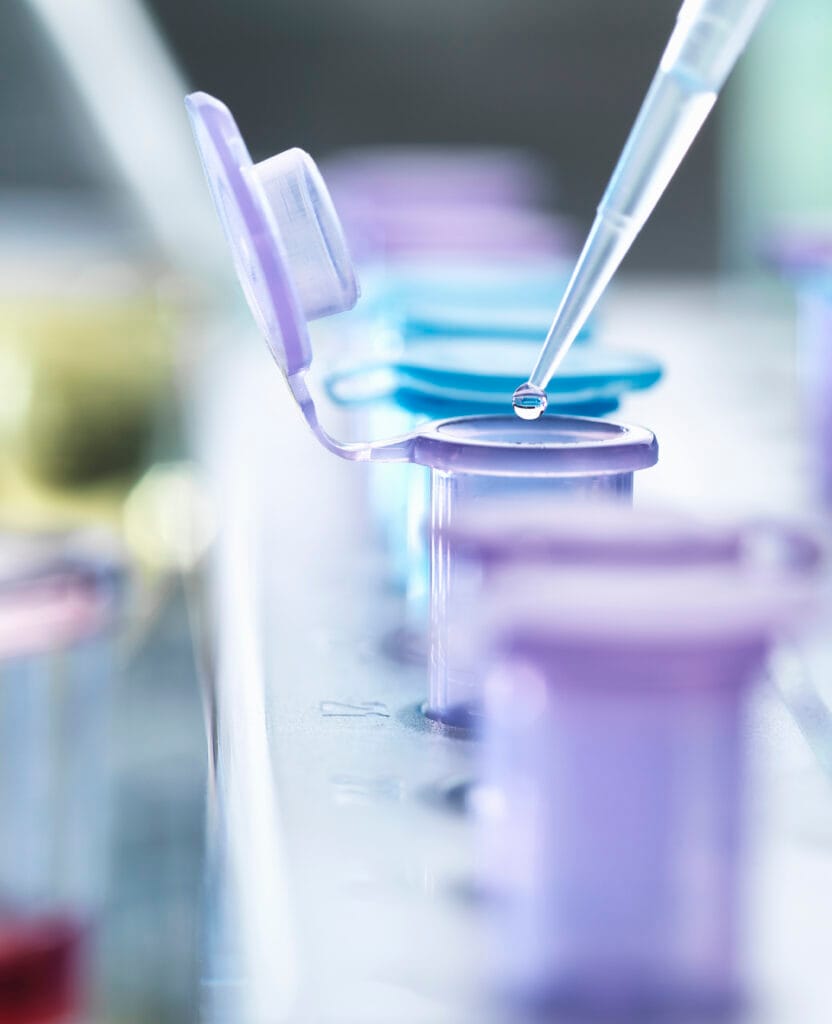 Pipetting droplets of liquid into eppendorf tubes, side view