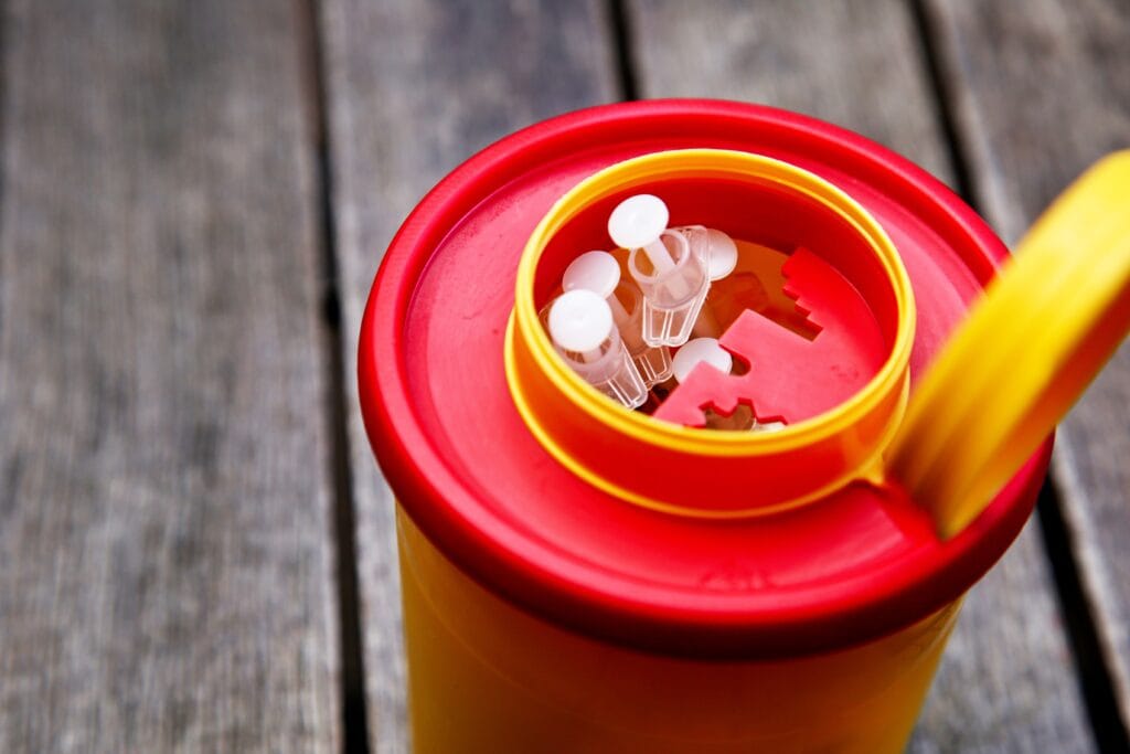 Closeup shot of an orange jar filled with needles